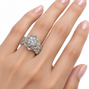 Unique Diamond Lotus Flower Engagement Ring on a feminine hand with pale pink manicure